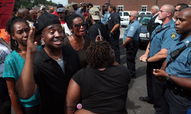 Protesters rally in front of Ferguson police station
